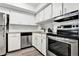 Kitchen with stainless appliances, granite countertops, new white cabinets and gray wood-look floors at 516 Polaris Loop # 110, Casselberry, FL 32707