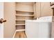 Laundry room with washer, dryer, storage shelving and wood-look floors at 516 Polaris Loop # 110, Casselberry, FL 32707