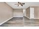 Living room with fresh paint, baseboards, ceiling fan, grey wood-look floors and natural light at 516 Polaris Loop # 110, Casselberry, FL 32707