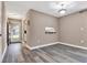 Living room with fresh paint, baseboards, grey wood-look floors and lots of natural light at 516 Polaris Loop # 110, Casselberry, FL 32707
