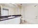 Bright bathroom featuring a vanity with sink, a mirror, and tub with shower at 5512 Metrowest Blvd # 203, Orlando, FL 32811