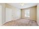 Neutral bedroom featuring tan walls, carpet and a window allowing natural light at 5512 Metrowest Blvd # 203, Orlando, FL 32811
