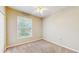 This bedroom features a large window, ceiling fan and closet for storage at 5512 Metrowest Blvd # 203, Orlando, FL 32811