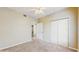 Neutral bedroom with carpeted floor, ceiling fan, and closet with paneled doors at 5512 Metrowest Blvd # 203, Orlando, FL 32811
