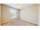 This bedroom features a ceiling fan and a large window for natural light at 5512 Metrowest Blvd # 203, Orlando, FL 32811