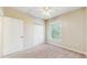 Bedroom featuring a carpeted floor, ceiling fan and bright, sunlit window at 5512 Metrowest Blvd # 203, Orlando, FL 32811
