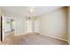 Spacious bedroom featuring neutral walls and carpet, ceiling fan and two doorways at 5512 Metrowest Blvd # 203, Orlando, FL 32811
