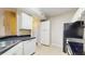 Functional kitchen featuring white cabinets, sleek countertops, and modern appliances at 5512 Metrowest Blvd # 203, Orlando, FL 32811