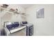 Laundry room with newer LG washer and dryer and overhead wire shelving at 5512 Metrowest Blvd # 203, Orlando, FL 32811