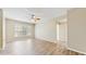 Spacious living room featuring wood-look floors and a large window for ample natural light at 5512 Metrowest Blvd # 203, Orlando, FL 32811