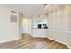 Stylish living area featuring wood-look floors, neutral walls, and an opening to the kitchen at 5512 Metrowest Blvd # 203, Orlando, FL 32811