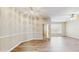 Comfortable living room boasts wood-look floors, neutral walls, and access to other rooms at 5512 Metrowest Blvd # 203, Orlando, FL 32811