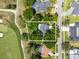 Aerial shot reveals the home surrounded by a lush golf course and mature trees, providing a serene and private setting at 6054 Tarawood Dr, Orlando, FL 32819