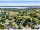Aerial view of a home nestled among mature trees, near a golf course and lake, in a picturesque residential area at 6054 Tarawood Dr, Orlando, FL 32819