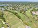 Gorgeous aerial view of the golf course, landscaping, and neighborhood with mature trees surrounding homes at 6054 Tarawood Dr, Orlando, FL 32819