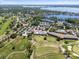 Aerial view featuring golf course, tennis courts, pool and clubhouse near the lake at 6054 Tarawood Dr, Orlando, FL 32819