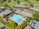 Stunning aerial view of a large community pool, with an expansive golf course in the background at 6054 Tarawood Dr, Orlando, FL 32819