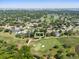 Beautiful aerial view showcases a well-manicured golf course community, surrounding a cozy home at 6054 Tarawood Dr, Orlando, FL 32819