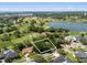 This aerial showcases the home's prime location near a golf course and lake, with lush greenery adding to its appeal at 6054 Tarawood Dr, Orlando, FL 32819