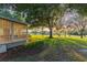 A cozy screened-in patio overlooks a verdant lawn and mature trees, offering a tranquil outdoor living space at 6054 Tarawood Dr, Orlando, FL 32819