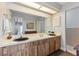 Bathroom with double vanity, laminate countertops, and wood cabinets at 6054 Tarawood Dr, Orlando, FL 32819