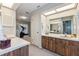 Bathroom featuring double sinks, custom cabinets, and a separate tub at 6054 Tarawood Dr, Orlando, FL 32819