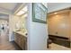 Bathroom with dual sinks, wood cabinets, tile floor and shower-tub combo at 6054 Tarawood Dr, Orlando, FL 32819