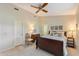 Bedroom with neutral walls, ceiling fan, carpet and ensuite bathroom at 6054 Tarawood Dr, Orlando, FL 32819
