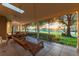 Charming covered patio features a porch swing and serene views of the golf course and landscape at 6054 Tarawood Dr, Orlando, FL 32819