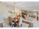 Elegant dining room boasts stylish chandelier, adjacent to a spacious living room with fireplace at 6054 Tarawood Dr, Orlando, FL 32819