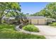 Inviting single-Gathering home featuring a well-maintained lawn and a driveway leading to a two-car garage at 6054 Tarawood Dr, Orlando, FL 32819