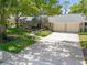 Charming single-story home with a spacious driveway, a lush landscaped garden, and an attached two-car garage at 6054 Tarawood Dr, Orlando, FL 32819