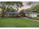 Attractive home with a well-maintained yard, a side-entry garage, mature trees, and nice landscaping at 6054 Tarawood Dr, Orlando, FL 32819