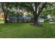 Charming home with mature trees, lush lawn, and well-maintained landscaping at 6054 Tarawood Dr, Orlando, FL 32819