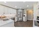 Modern kitchen with stainless steel appliances, white cabinetry, and hardwood floors at 6054 Tarawood Dr, Orlando, FL 32819