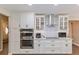 Updated kitchen showcasing double oven, cooktop and custom cabinets at 6054 Tarawood Dr, Orlando, FL 32819