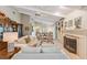 Spacious living room with fireplace, built-in bookshelves, and plenty of natural light at 6054 Tarawood Dr, Orlando, FL 32819