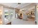 Bright living room with fireplace, beamed ceiling, and French doors to outdoor patio at 6054 Tarawood Dr, Orlando, FL 32819