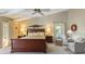Cozy main bedroom with ceiling fan and view of rear yard through large windows at 6054 Tarawood Dr, Orlando, FL 32819