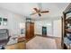 Bright home office space with hardwood flooring, built-in shelving, and a work desk at 6054 Tarawood Dr, Orlando, FL 32819
