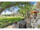 This patio has a firepit, white chairs and a beautiful lawn view at 6054 Tarawood Dr, Orlando, FL 32819