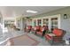 Charming patio with four wicker chairs, a ceiling fan, and beautiful doors letting light into the home at 6054 Tarawood Dr, Orlando, FL 32819