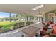 Covered patio with orange wicker chairs and views of lush green lawn and trees at 6054 Tarawood Dr, Orlando, FL 32819