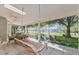 Screened patio with stone floor, swing and table with chairs overlooking golf course at 6054 Tarawood Dr, Orlando, FL 32819
