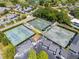 Aerial view of well-maintained tennis courts within the community, surrounded by greenery and parking at 6054 Tarawood Dr, Orlando, FL 32819
