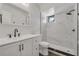 Modern bathroom features elegant marble tiling in the shower and white vanity with bronze hardware at 66 Silver Falls Cir, Kissimmee, FL 34743