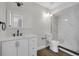 Modern bathroom featuring a white vanity, stylish light fixtures, and glass-enclosed shower at 66 Silver Falls Cir, Kissimmee, FL 34743