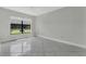 Bright bedroom featuring large window, neutral walls, and tile flooring at 66 Silver Falls Cir, Kissimmee, FL 34743