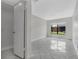 Cozy bedroom with bright tile flooring, walk-in closet, and a large window for natural lighting at 66 Silver Falls Cir, Kissimmee, FL 34743