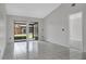 Bright and airy living room featuring white tile floors and access to an enclosed back patio at 66 Silver Falls Cir, Kissimmee, FL 34743